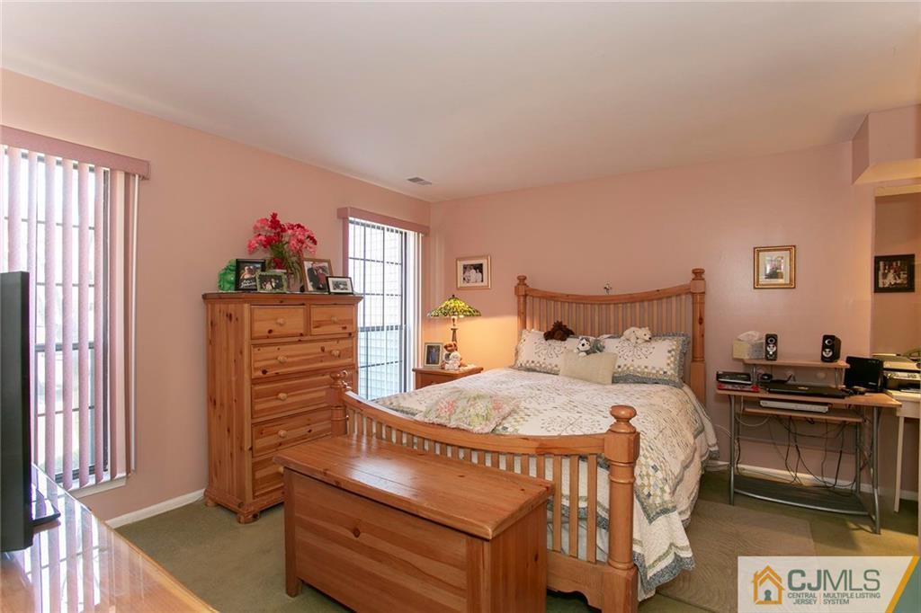 1206 Maplecrest Road Edison, NJ 08820 - Photo 11 of 15 a bedroom with a bed and wooden floor