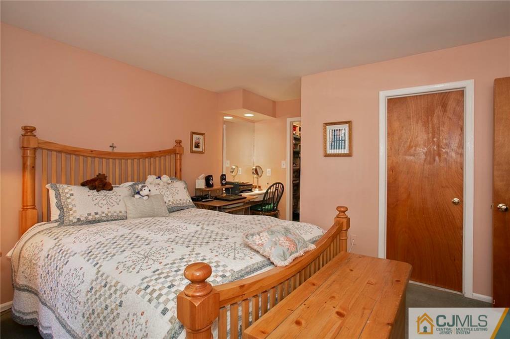 1206 Maplecrest Road Edison, NJ 08820 - Photo 12 of 15 a large bed sitting in a bedroom next to a cabinet