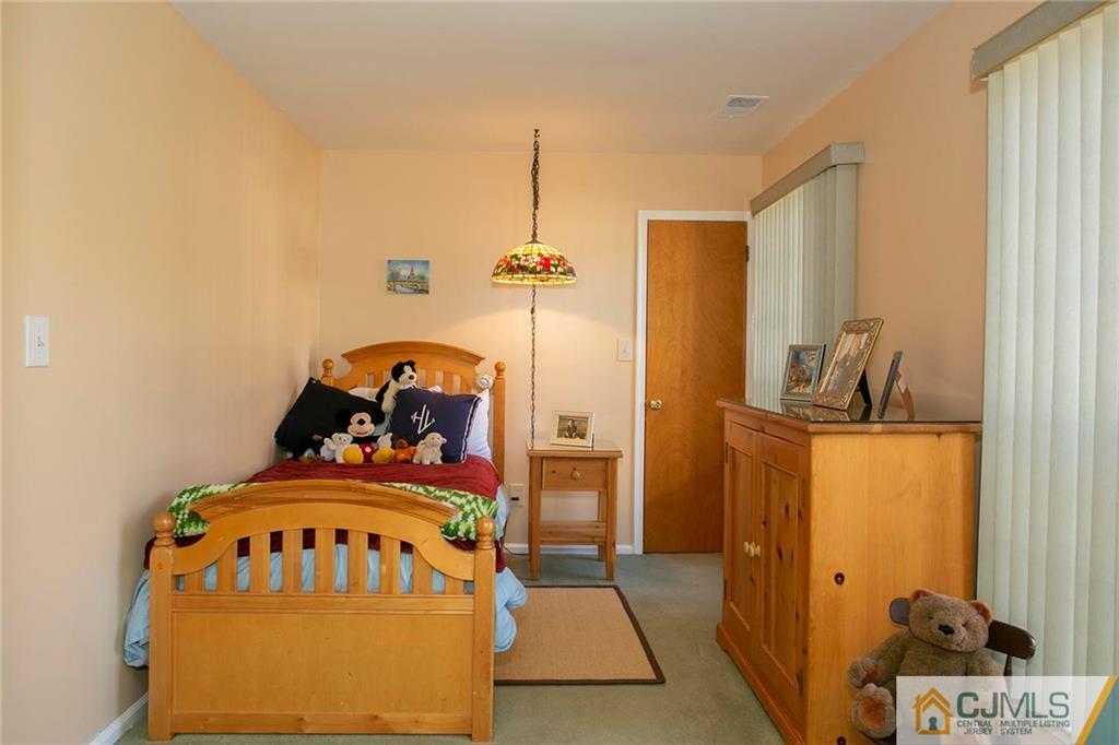 1206 Maplecrest Road Edison, NJ 08820 - Photo 13 of 15 a bedroom with a bed and a dresser