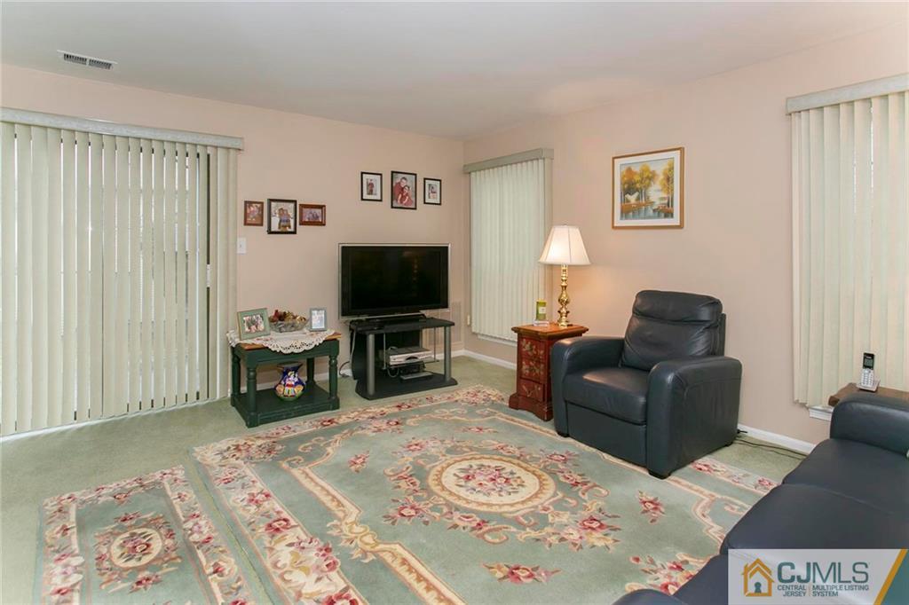 1206 Maplecrest Road Edison, NJ 08820 - Photo 5 of 15 a living room with furniture and a flat screen tv