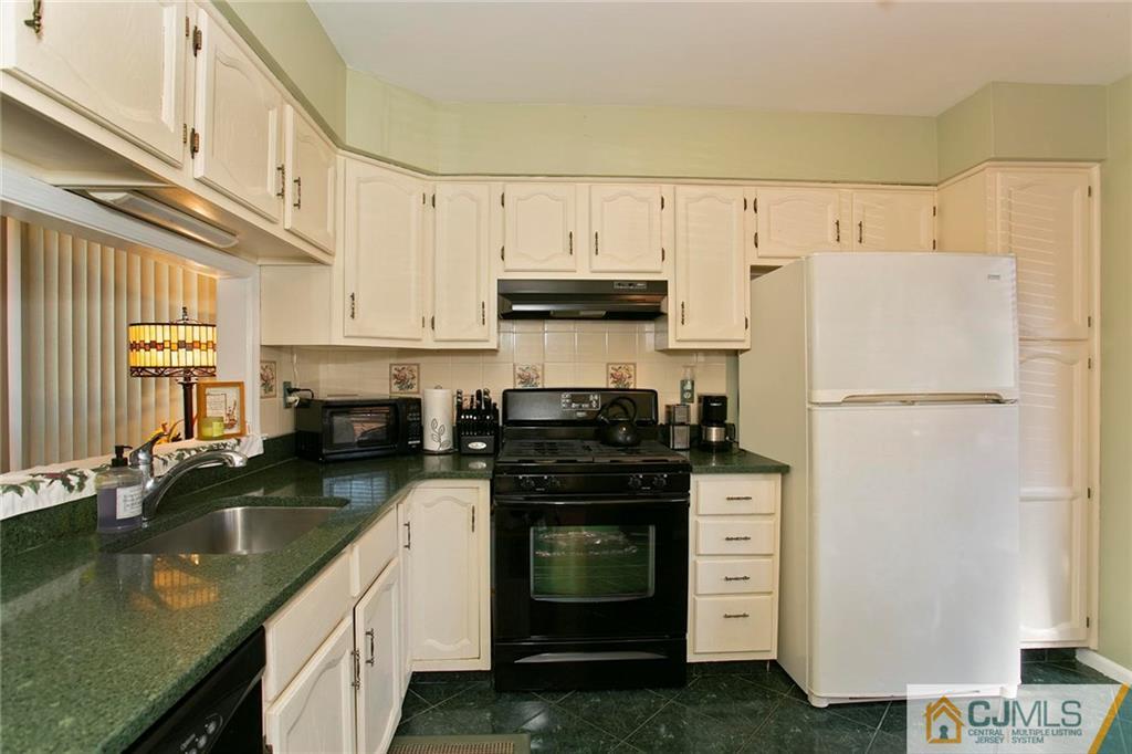 1206 Maplecrest Road Edison, NJ 08820 - Photo 8 of 15 a kitchen with granite countertop a refrigerator stove and sink