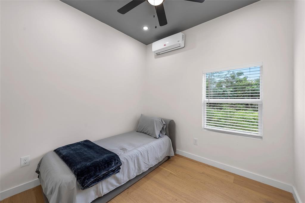 113 County Road Marlin, TX 76661 - Photo 8 of 11 a bedroom with a bed lamp and a chandelier