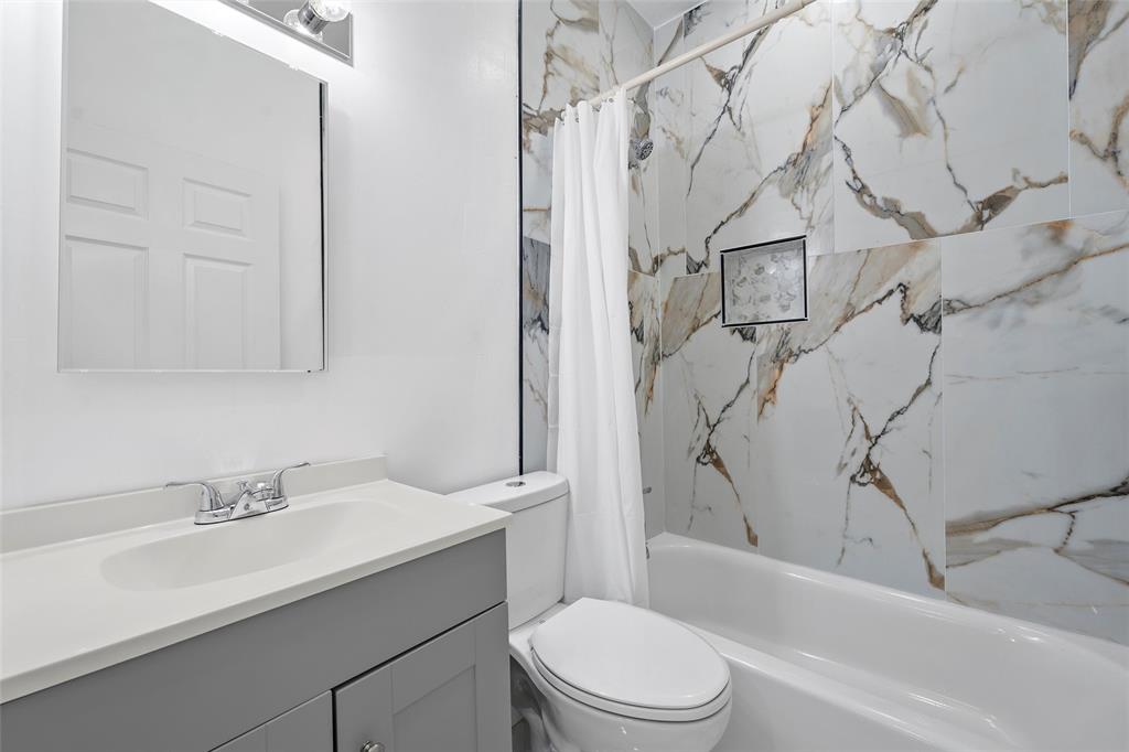 113 County Road Marlin, TX 76661 - Photo 10 of 11 a bathroom with a sink toilet vanity and shower