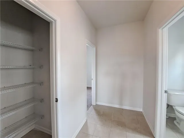 an empty room with windows and closet in a room