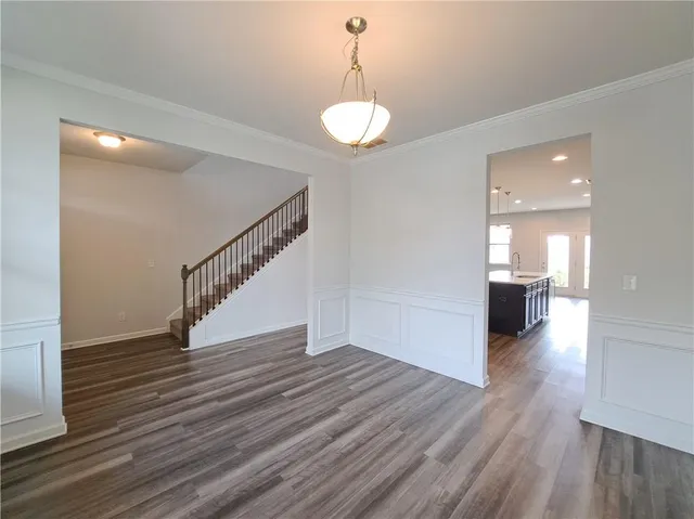 a kitchen with stainless steel appliances granite countertop a kitchen island hardwood floor sink stove and granite counter top