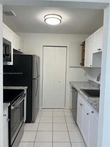 a kitchen with a stove and a refrigerator