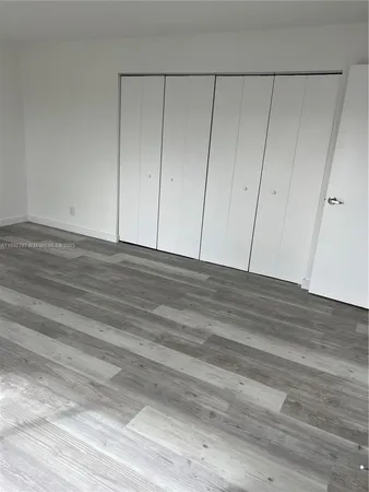 a view of room with wooden floor