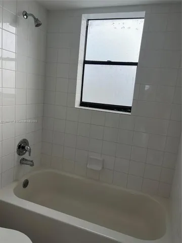 a bathroom with a shower and a bathtub