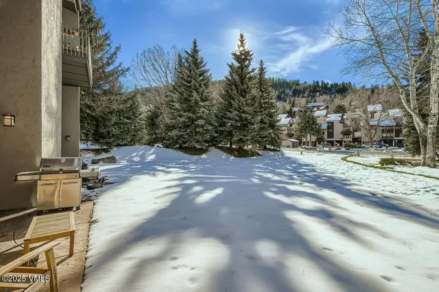 a building outdoor space with patio furniture and potted plants