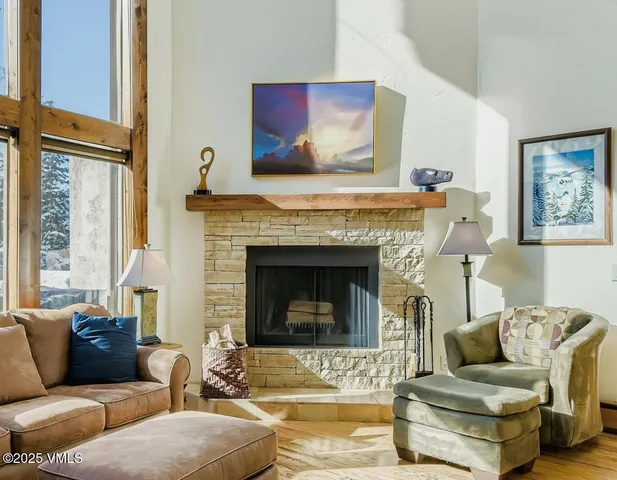 a living room with furniture wooden floor and a fireplace
