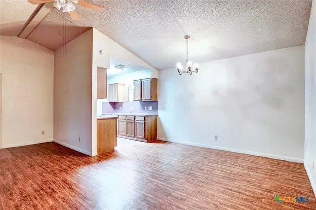 a view of a kitchen with wooden floor and a kitchen