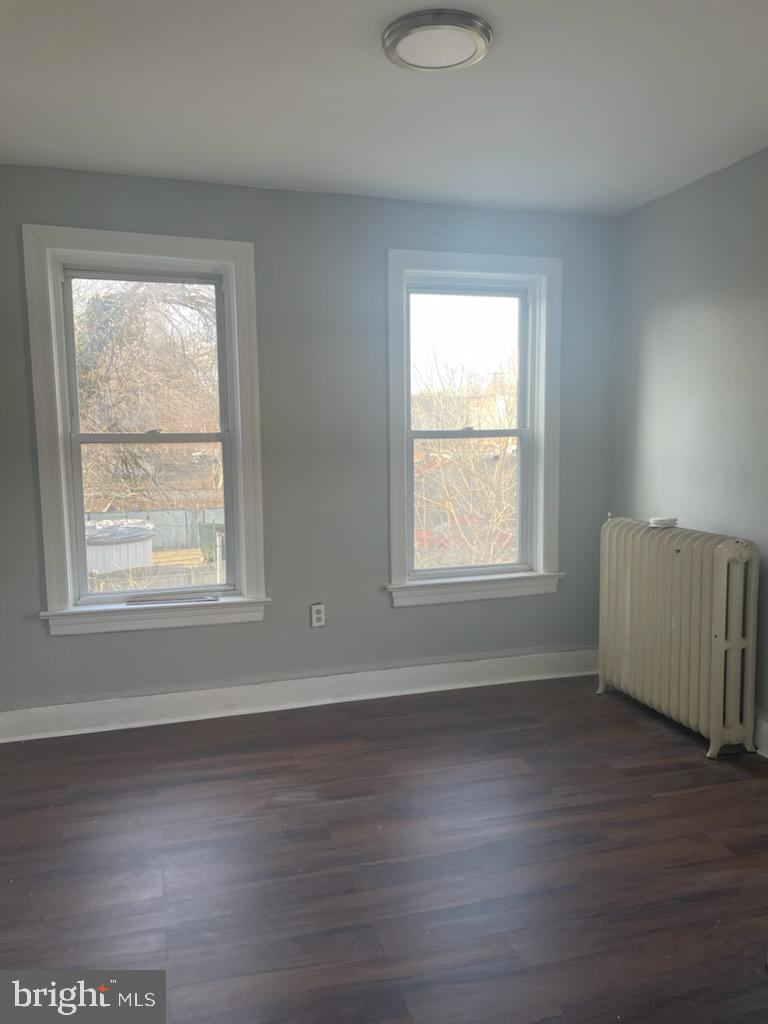 1111 South 4th Street, Unit B Camden, NJ 08103 - Photo 11 of 11 a view of an empty room with wooden floor and a window