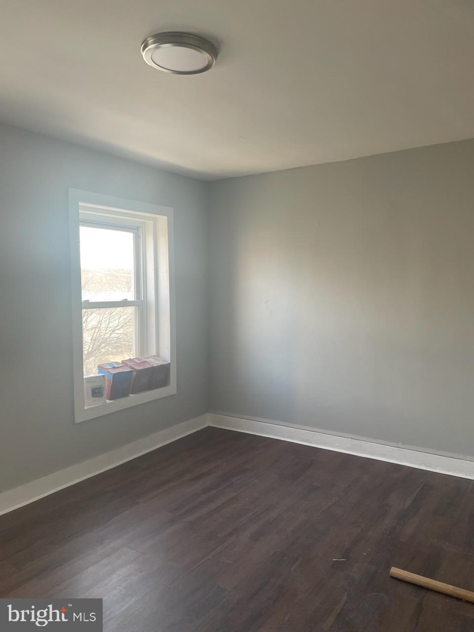 1111 South 4th Street, Unit B Camden, NJ 08103 - Photo 4 of 11 an empty room with wooden floor and windows
