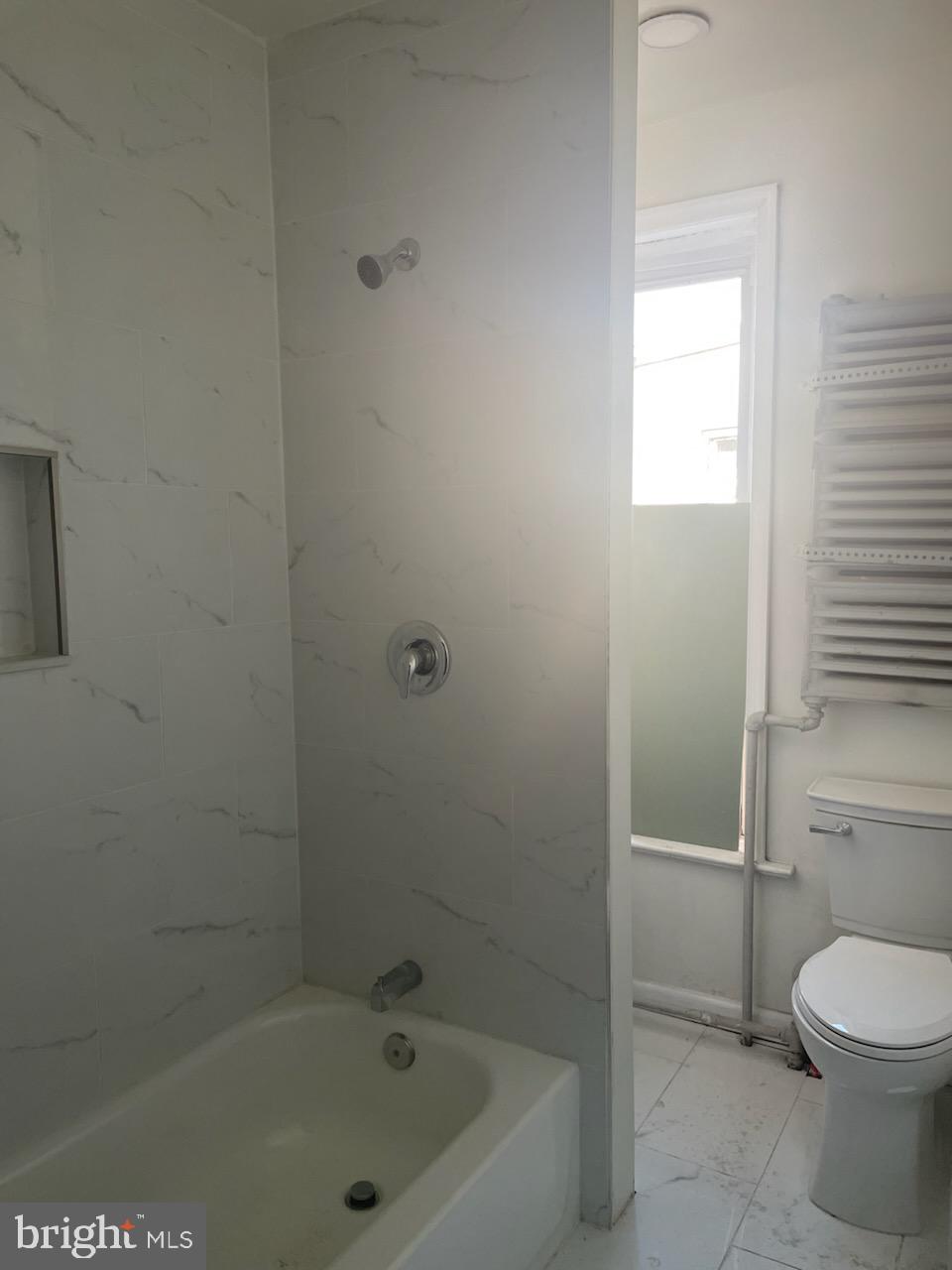 1111 South 4th Street, Unit B Camden, NJ 08103 - Photo 8 of 11 a bathroom with a bathtub and a toilet