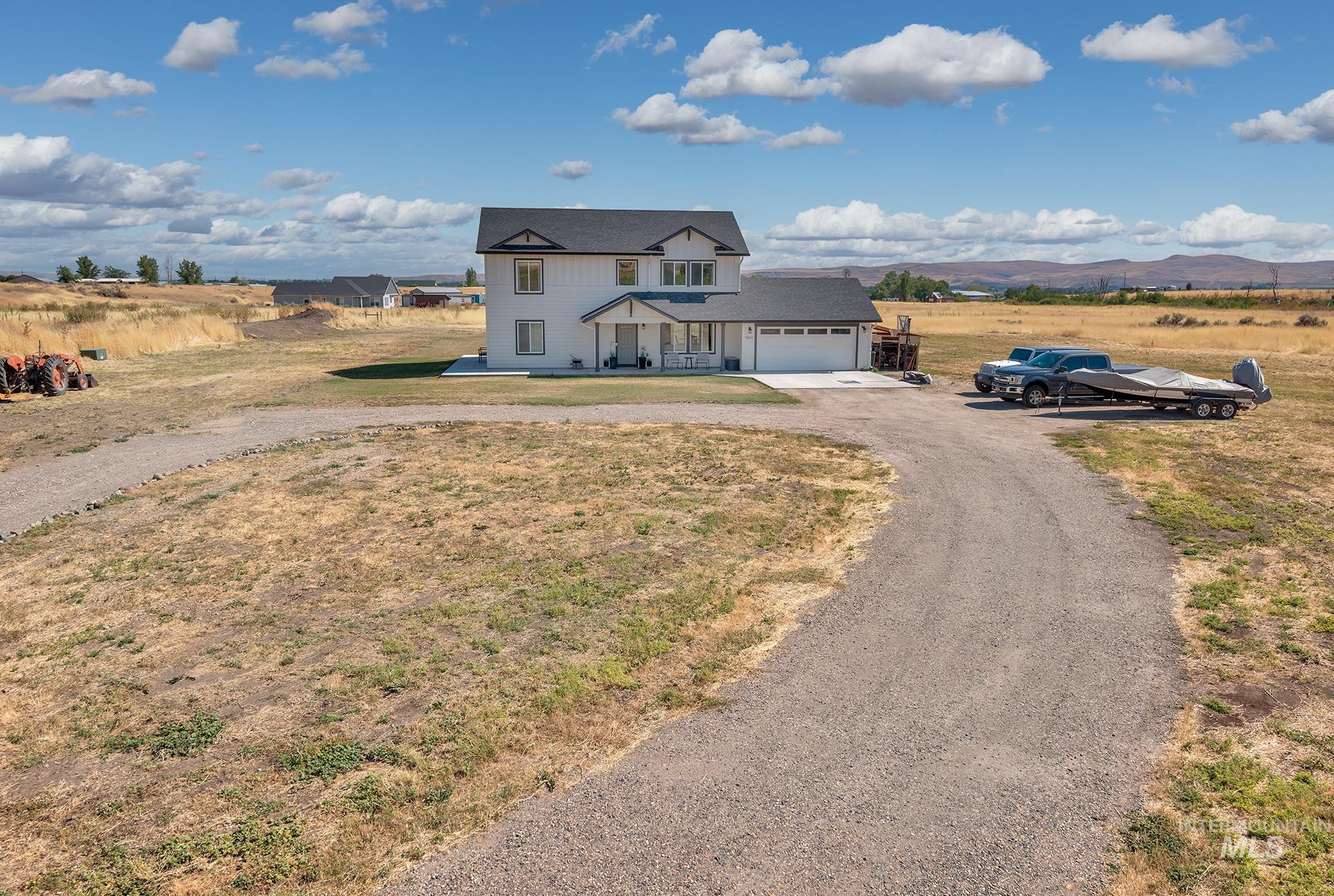 1049 Price Road Weiser, ID 83672 - Photo 43 of 47 White two-story residence with a black shingled roof