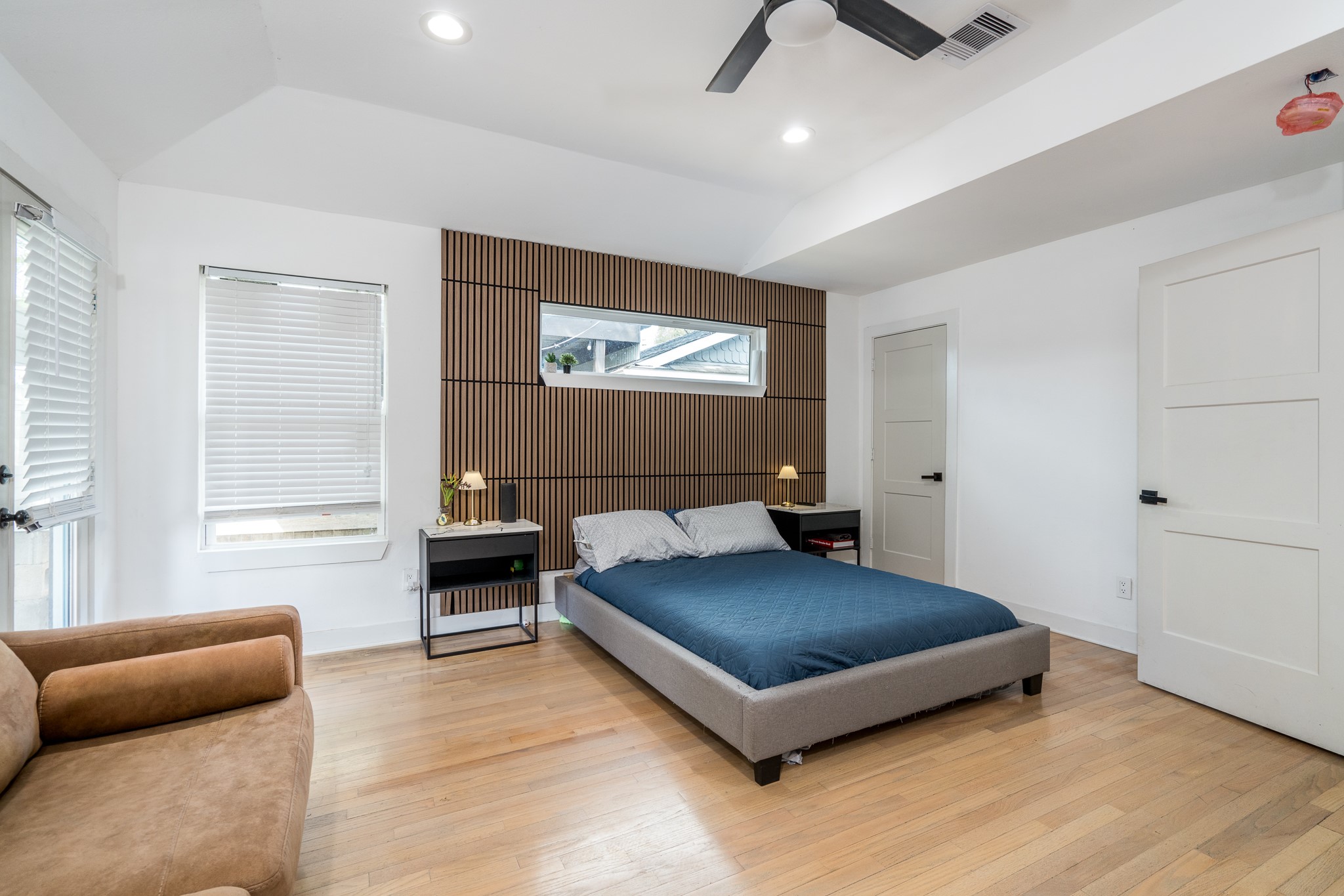 810 Jerry Street Houston, TX 77022 - Photo 11 of 20 Vast primary bedroom with striking wood accent wall