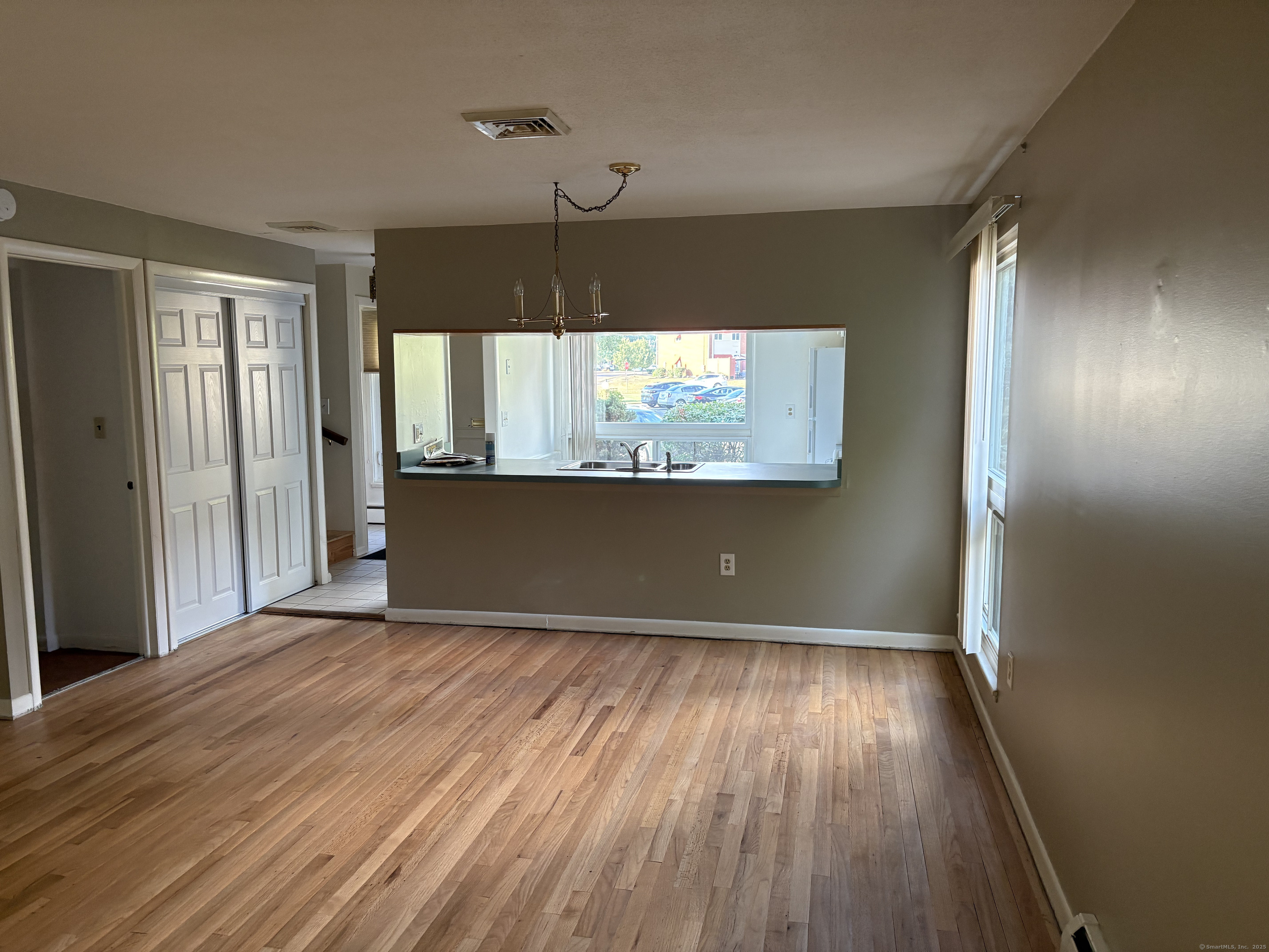 279 Centerbrook Road Hamden, CT 06518 - Photo 5 of 10 an empty room with wooden floor and windows