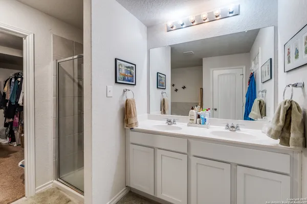 a bathroom with a double vanity sink and mirror