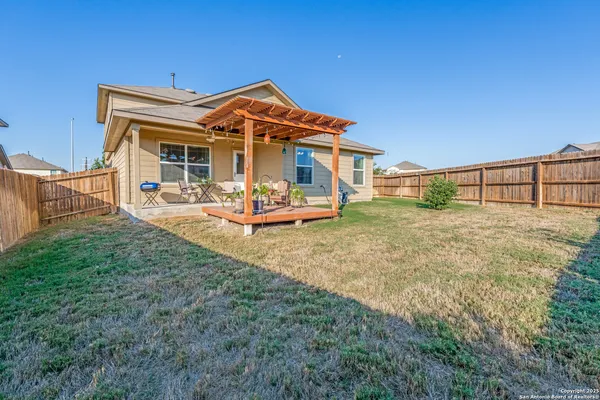 a backyard of a house with table and chairs