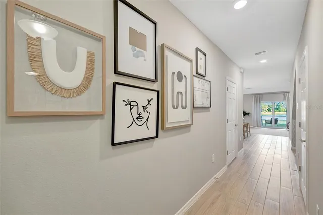 a kitchen with stainless steel appliances kitchen island granite countertop a stove a sink a dining table and chairs with wooden floor