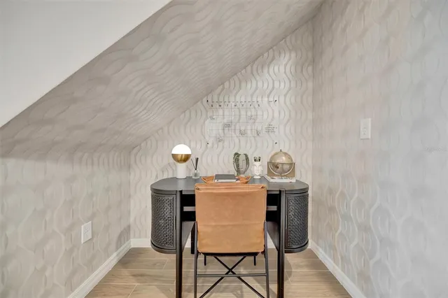 a kitchen with stainless steel appliances granite countertop a sink a stove a refrigerator cabinets and chairs