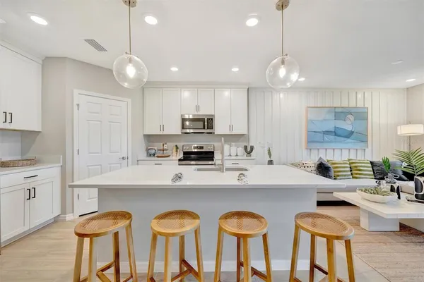 a kitchen with stainless steel appliances kitchen island granite countertop a sink and cabinets