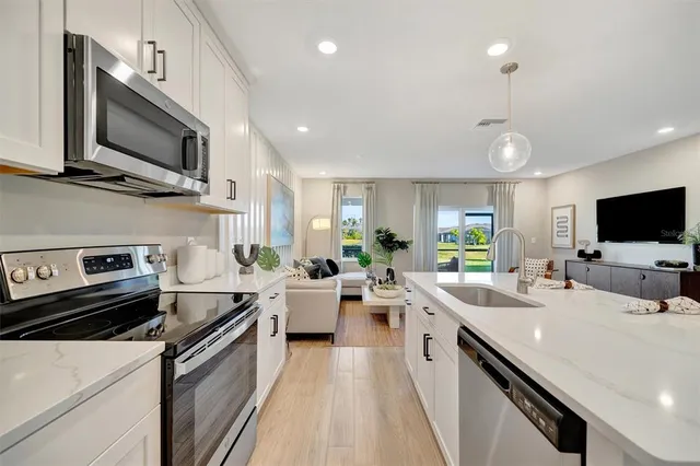 a living room with furniture and kitchen view