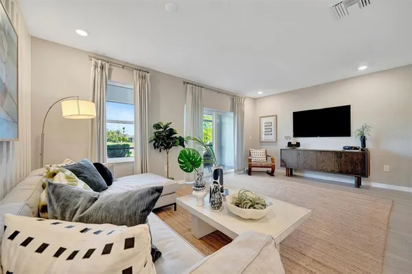 a bedroom with a bed and a potted plant