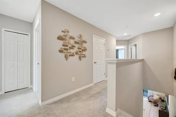 a bedroom with a bed a mirror on dresser and a chandelier