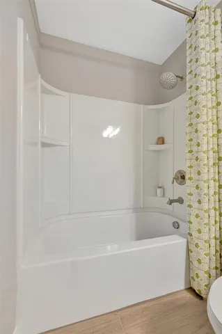 a living room with furniture a flat screen tv and a floor to ceiling window