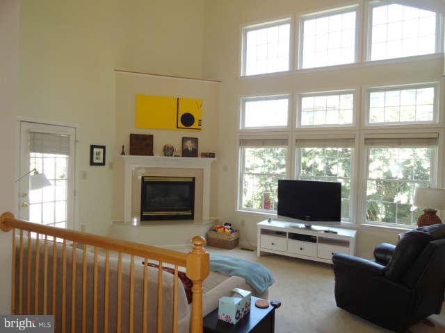 2556 Bear Den Road Frederick, MD 21701 - Photo 14 of 30 a living room with furniture a flat screen tv and a fireplace