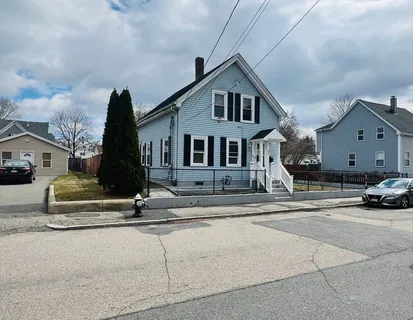 a front view of a house with a parking space