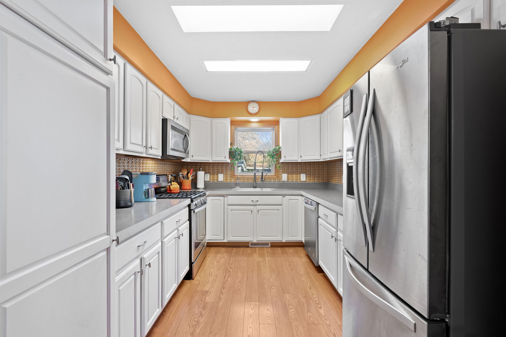 1216 Candlewood Road Elgin, IL 60123 - Photo 13 of 24 a kitchen with stainless steel appliances a refrigerator sink and white cabinets