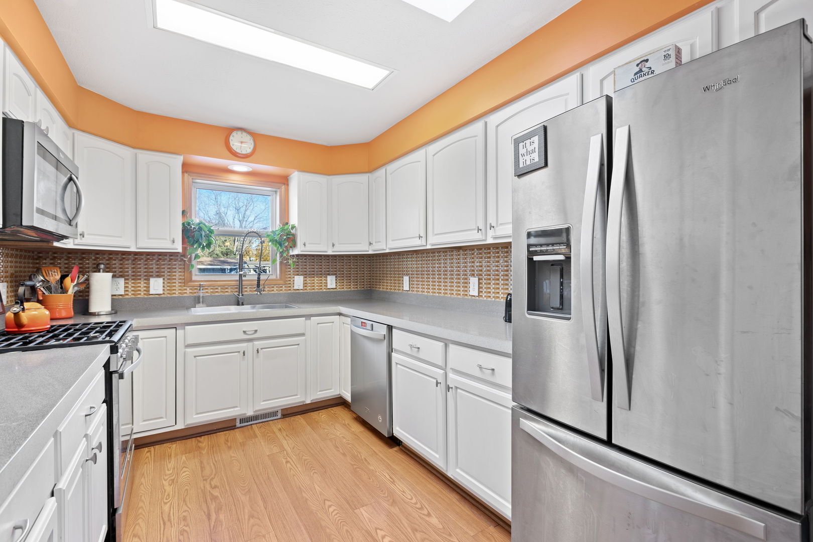 1216 Candlewood Road Elgin, IL 60123 - Photo 14 of 24 a kitchen with stainless steel appliances granite countertop a refrigerator sink and cabinets
