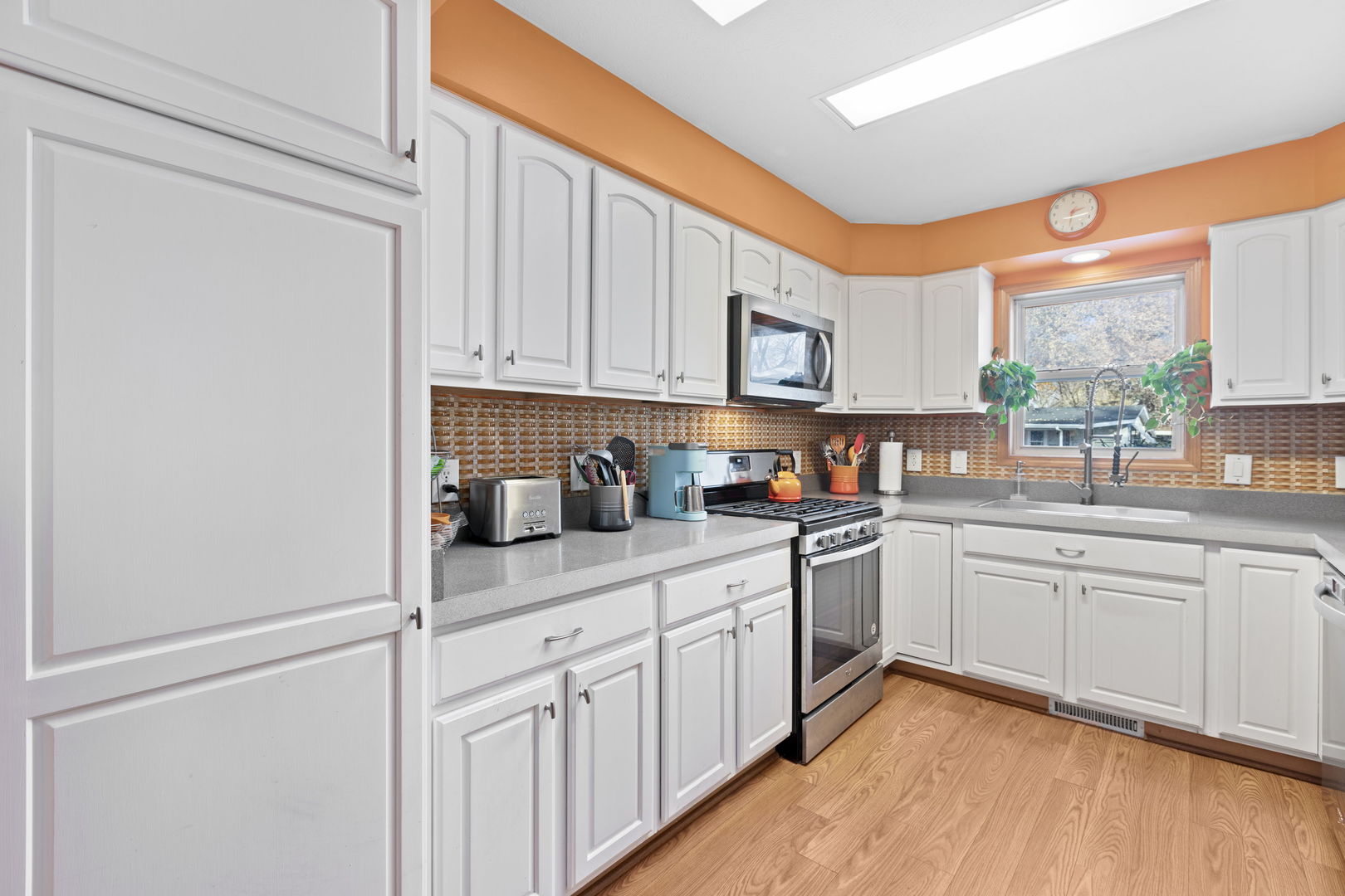 1216 Candlewood Road Elgin, IL 60123 - Photo 15 of 24 a kitchen with stainless steel appliances granite countertop refrigerator sink and cabinets