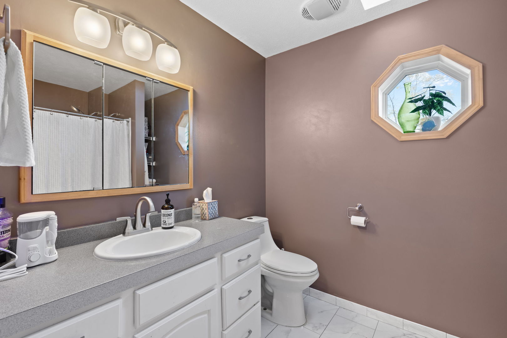 1216 Candlewood Road Elgin, IL 60123 - Photo 18 of 24 a bathroom with a toilet sink and mirror
