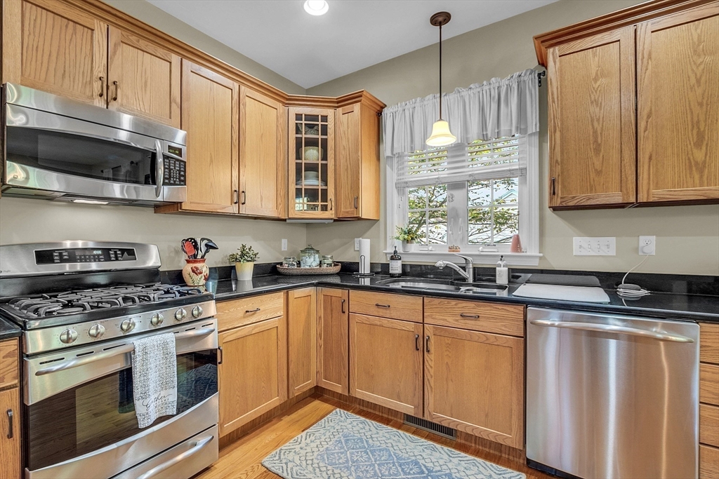 124 Nicholas Drive Lancaster, MA 01523 - Photo 16 of 42 a kitchen with stainless steel appliances granite countertop a sink a stove and cabinets