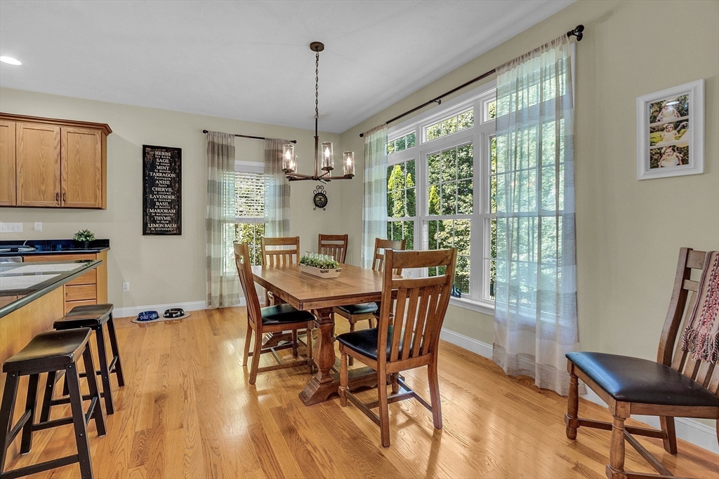 124 Nicholas Drive Lancaster, MA 01523 - Photo 19 of 42 a view of a dining room with furniture window and wooden floor