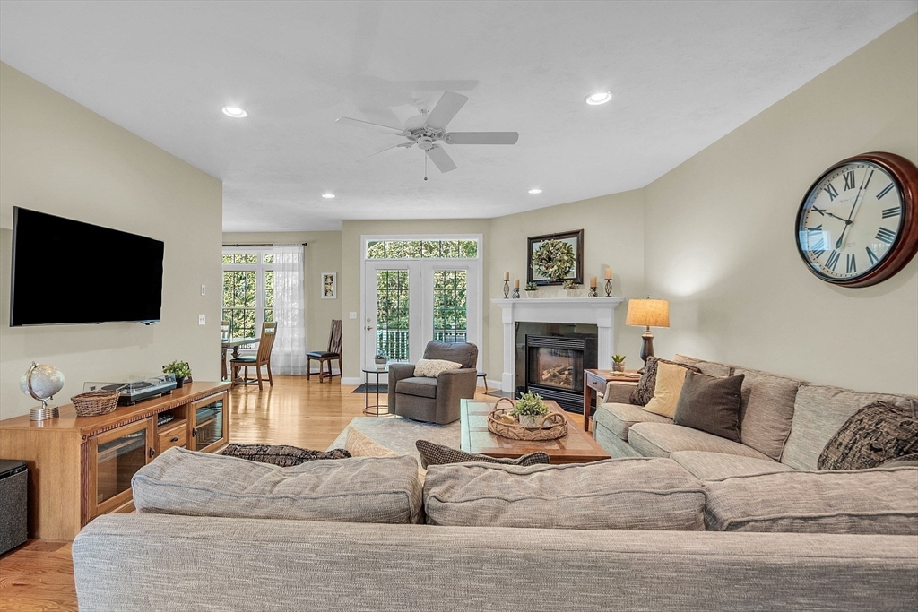 124 Nicholas Drive Lancaster, MA 01523 - Photo 23 of 42 a living room with furniture a fireplace and a flat screen tv
