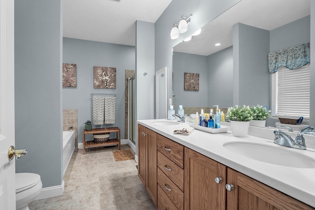 124 Nicholas Drive Lancaster, MA 01523 - Photo 29 of 42 a spacious bathroom with a double vanity sink mirror and toilet