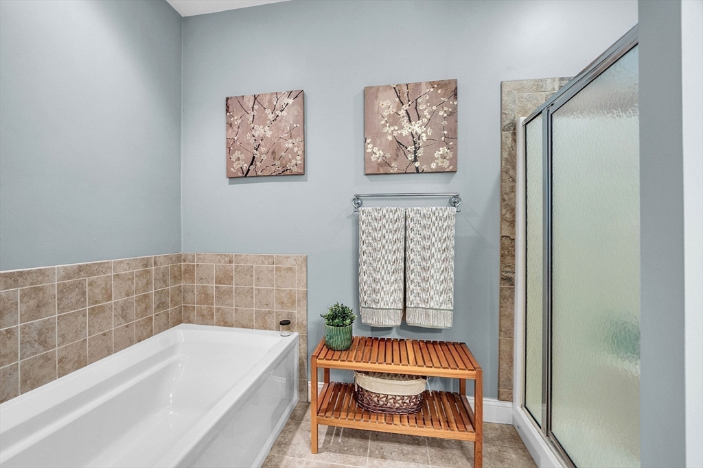 124 Nicholas Drive Lancaster, MA 01523 - Photo 30 of 42 a bathroom with a bathtub and a shower
