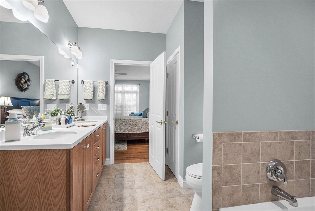 124 Nicholas Drive Lancaster, MA 01523 - Photo 31 of 42 a spacious bathroom with a double vanity sink a mirror and a bathtub