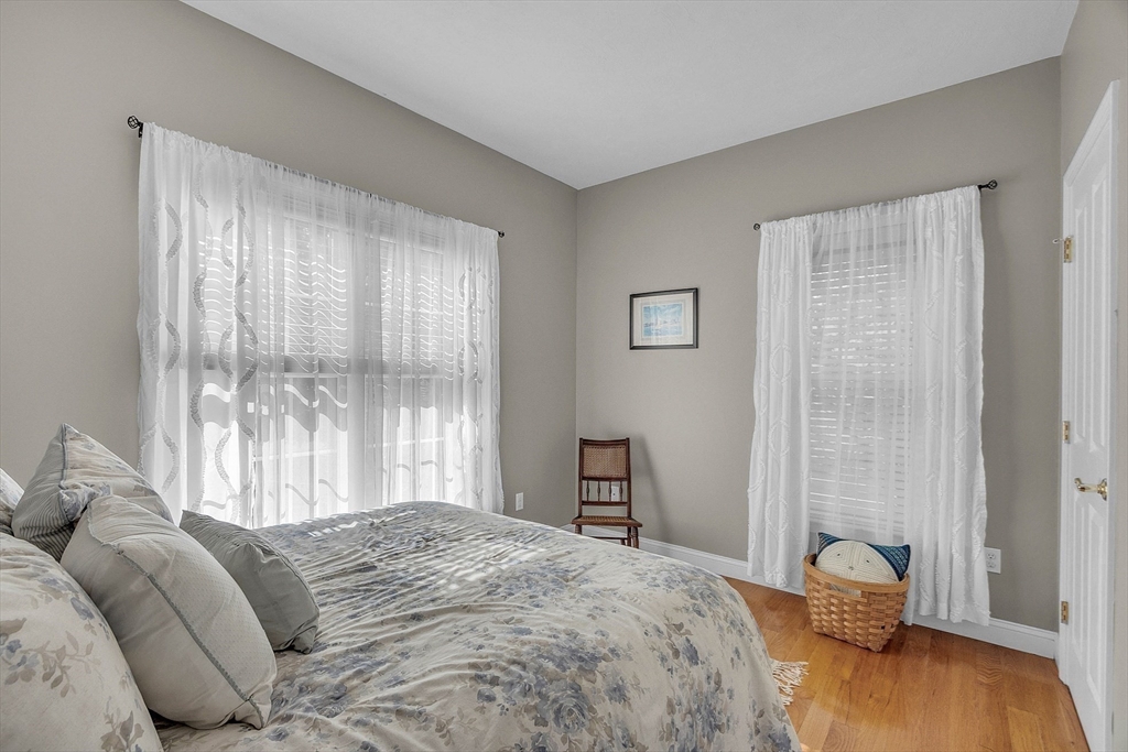 124 Nicholas Drive Lancaster, MA 01523 - Photo 33 of 42 a bedroom with a bed and wooden floor