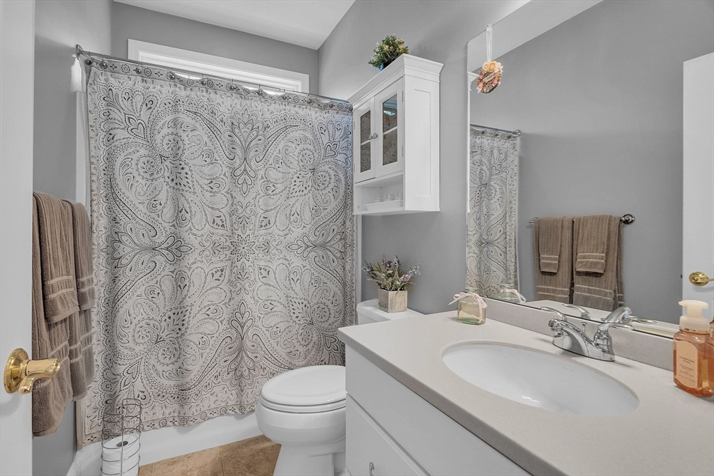 124 Nicholas Drive Lancaster, MA 01523 - Photo 34 of 42 a bathroom with a granite countertop sink toilet and shower