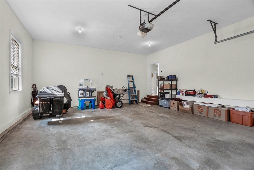 124 Nicholas Drive Lancaster, MA 01523 - Photo 40 of 42 a view of a garage with furniture and a window