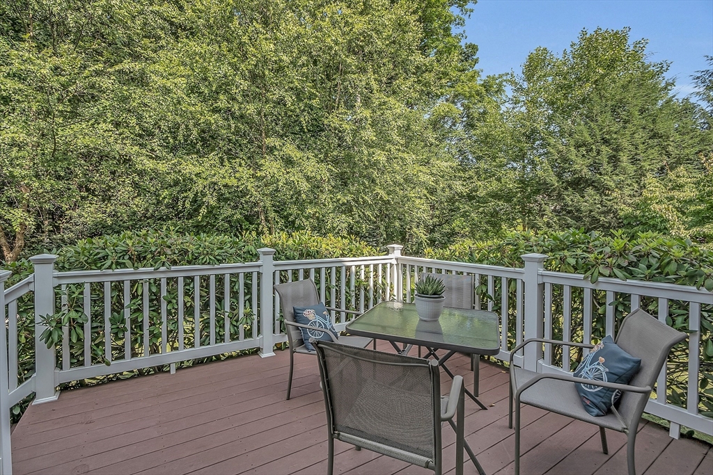 124 Nicholas Drive Lancaster, MA 01523 - Photo 8 of 42 a view of a chair and table on the deck