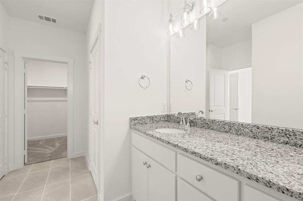 1827 Azalea Drive Melissa, TX 75454 - Photo 22 of 38 a bathroom with a granite countertop sink and a mirror