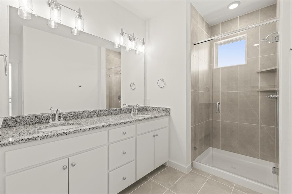 1827 Azalea Drive Melissa, TX 75454 - Photo 23 of 38 a bathroom with a granite countertop sink a mirror a shower and a bathtub