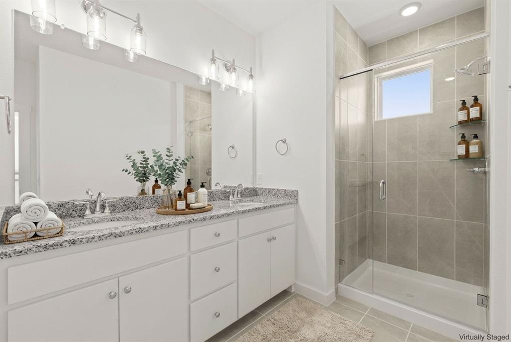 1827 Azalea Drive Melissa, TX 75454 - Photo 24 of 38 a bathroom with a granite countertop sink a mirror and a shower