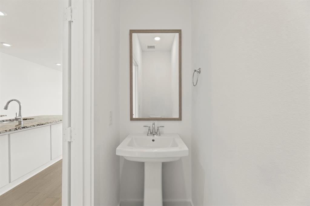 1827 Azalea Drive Melissa, TX 75454 - Photo 32 of 38 a bathroom with a sink and a mirror